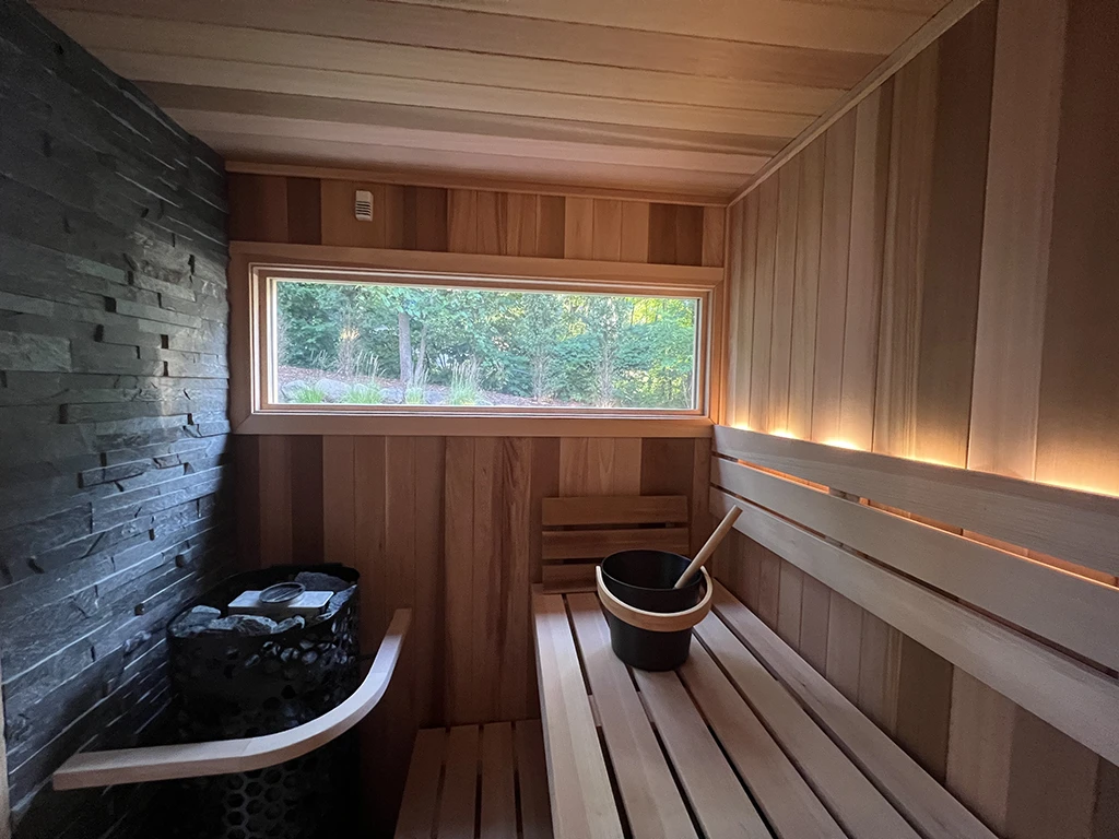 custom cedar sauna interior with plants in background