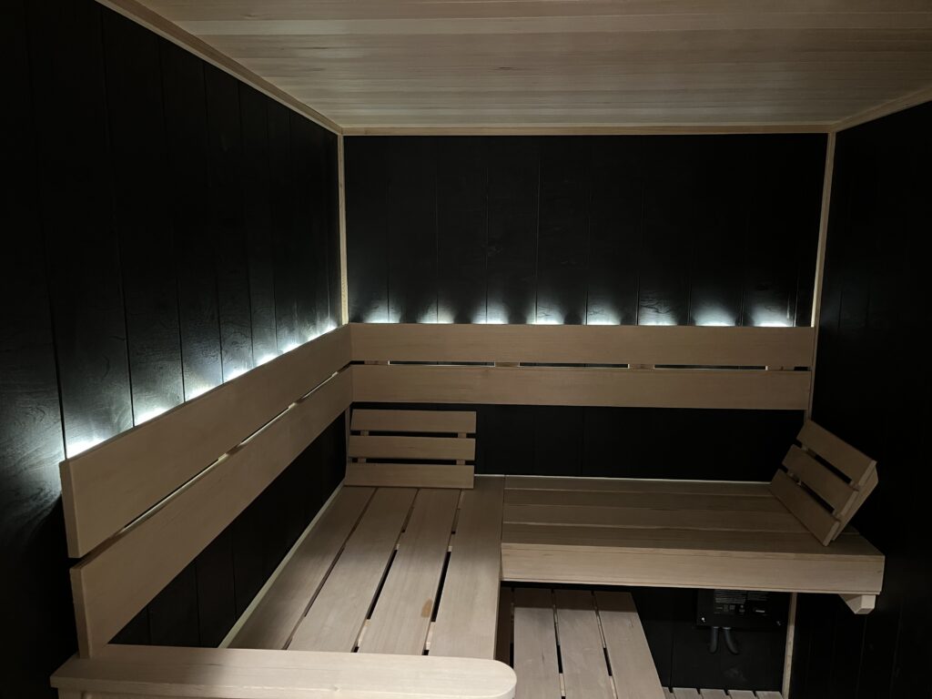 custom finnleo black taika with hemlock benching and backrest sauna