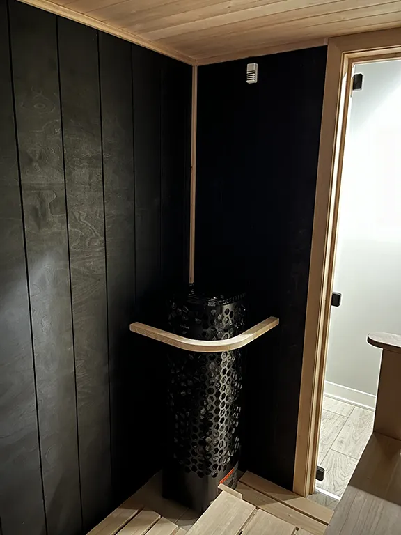 custom black taika sauna with himalaya heater