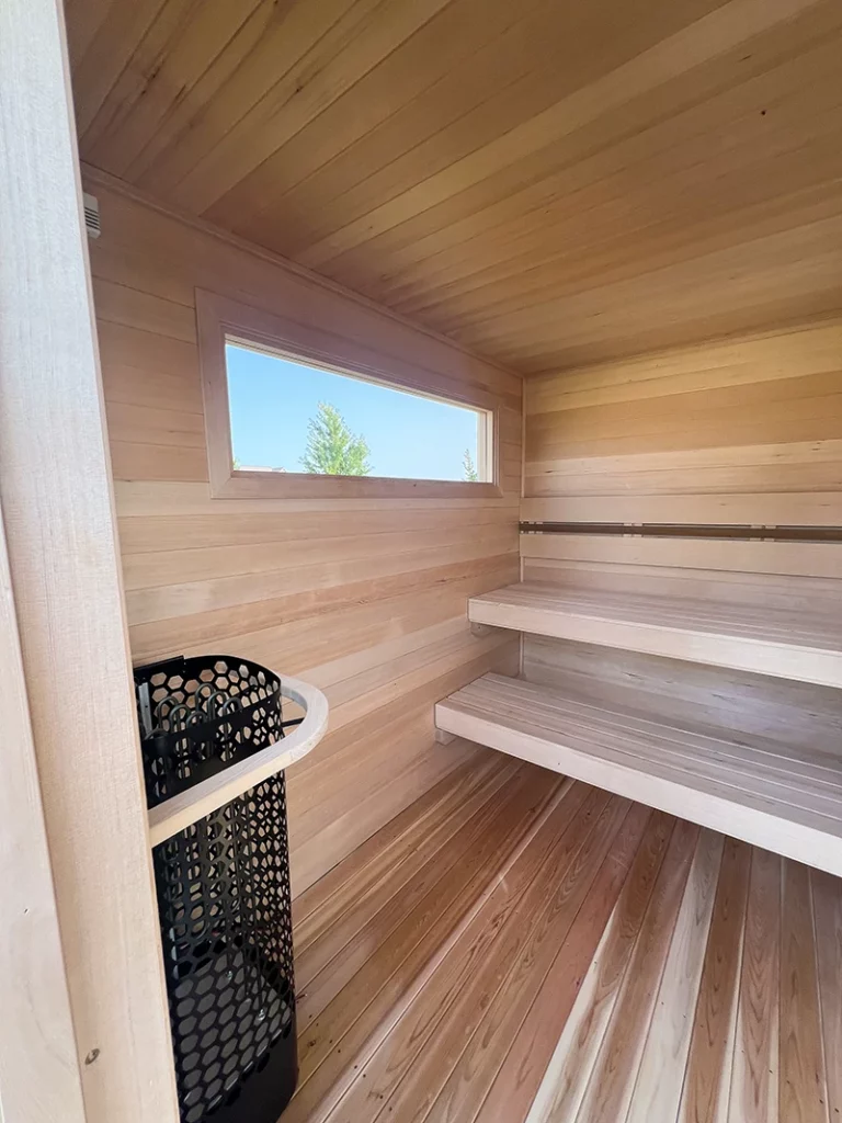 custom hemlock sauna interior with finnleo himalaya rock tower