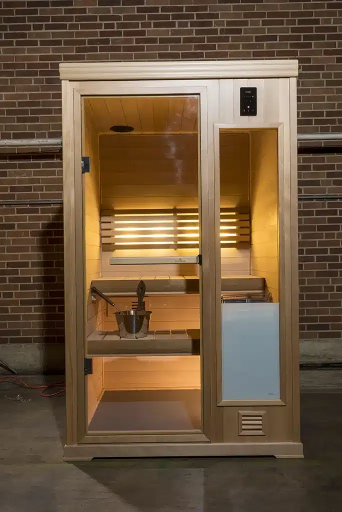 finnleo hallmark 4x4 traditional modular sauna in front of brick wall