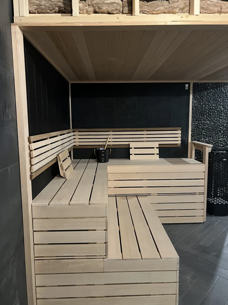 custom finnleo black taika sauna with hemlock benching and bench skirts