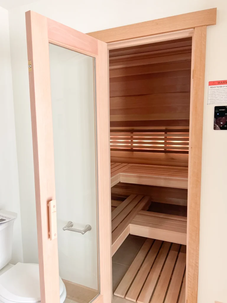 cedar sauna with six bar curved backrest and douglas fir frame door