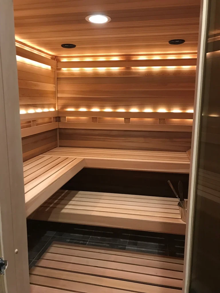 custom finnleo cedar sauna with 2 bar backrest and valence lighting