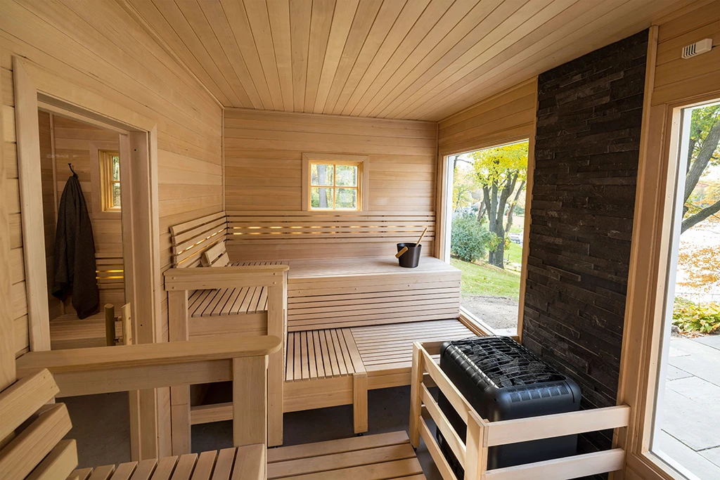 large custom hemlock sauna with two glass windows on front