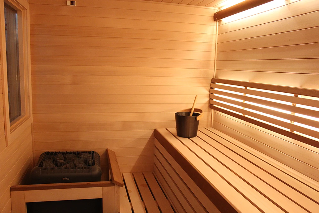 custom finnleo hemlock sauna with valence lighting and six bar curved backrest