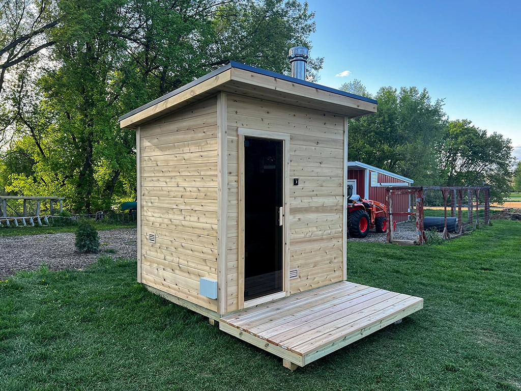 custom outdoor wood-fired traditional sauna with knotty cedar