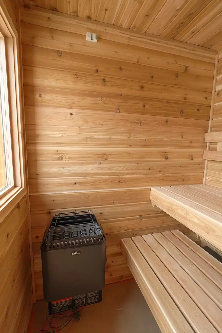 knotty cedar sauna with wall mounted finnleo designer heater.