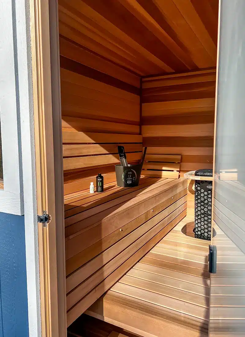 left bench in 7x8 blue custom outdoor sauna with clear cedar interior