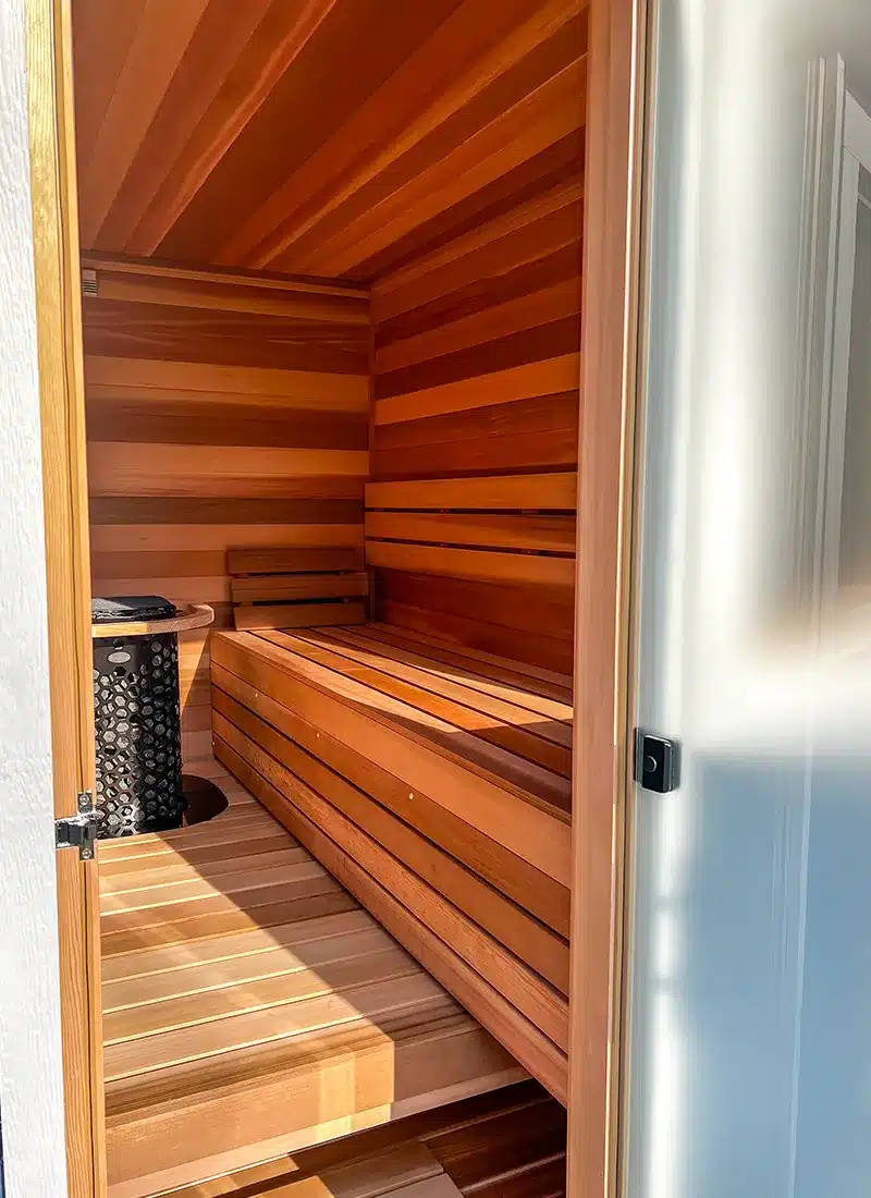 right bench in 7x8 blue custom outdoor sauna with clear cedar interior