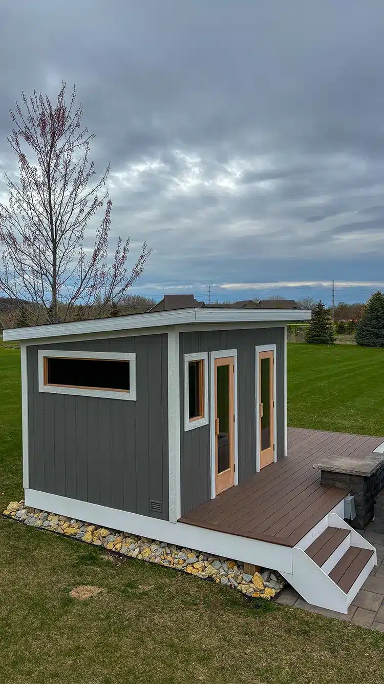 Gray custom built outdoor sauna on finished deck