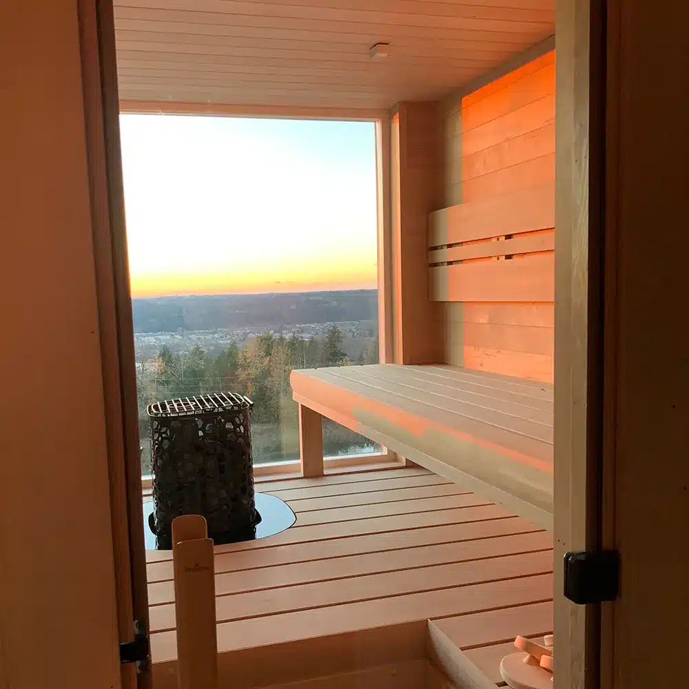 hemlock sauna with large window looking out at trees