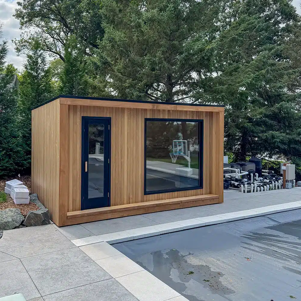 custom built outdoor sauna with thermo-aspen exterior and large glass window on the front