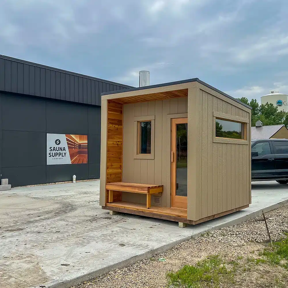 custom brown sauna with porch and overhang, douglas fir frame door, wood-fired iki heater