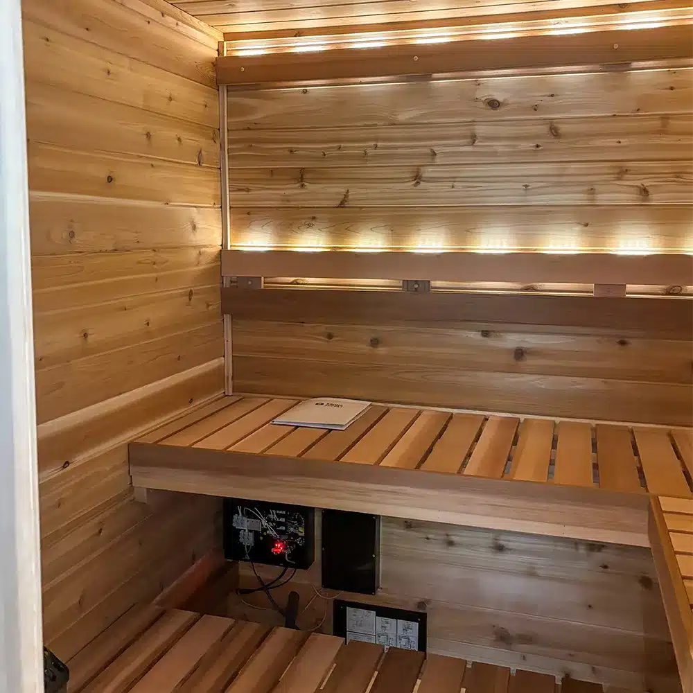 custom knotty cedar indoor sauna with backrest and valence lighting