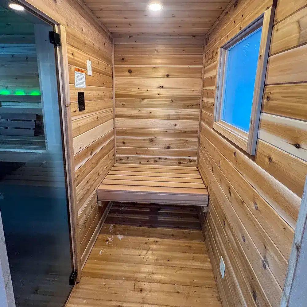knotty cedar changing room in custom sauna in woods